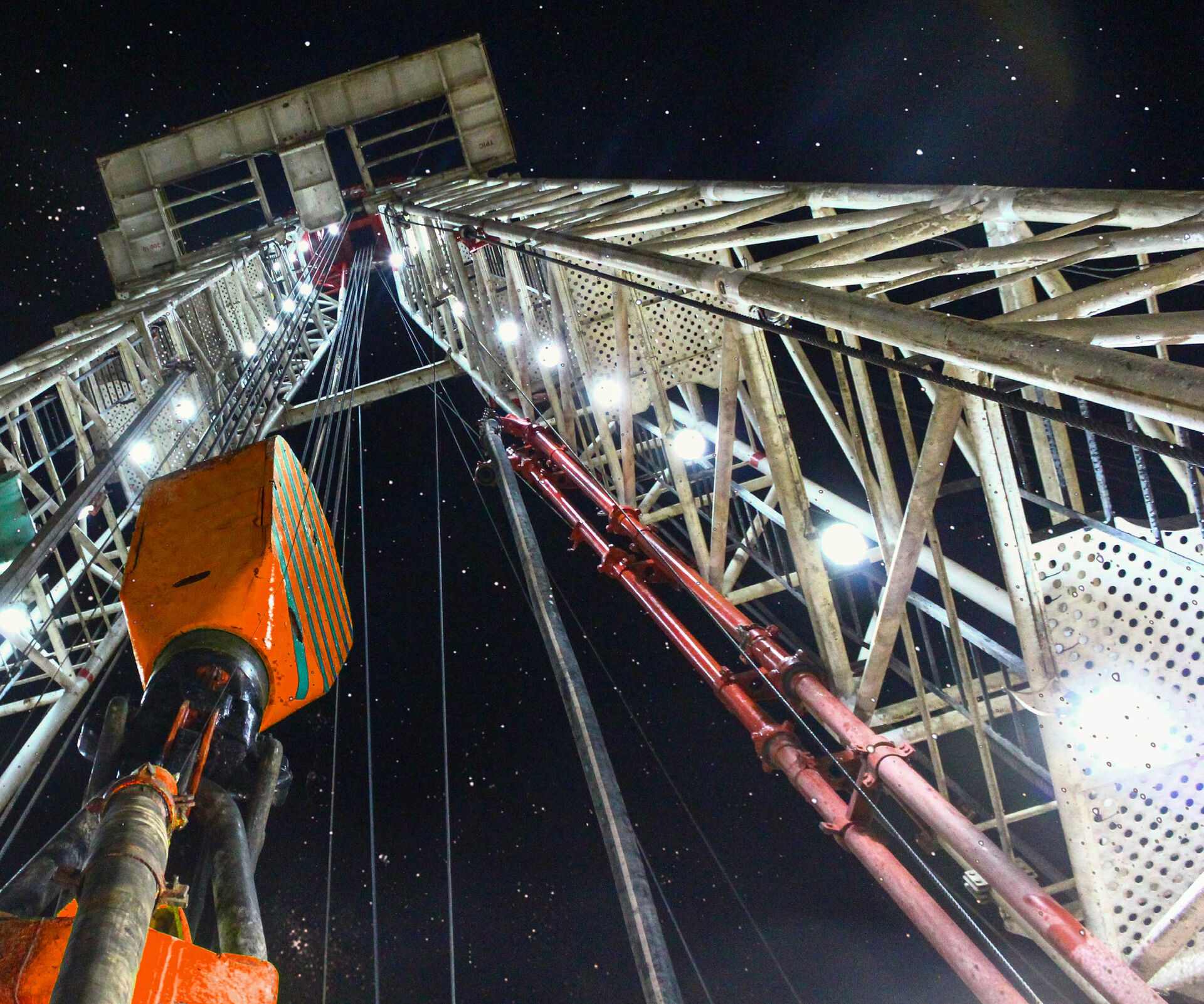 Geothermal drilling rig operating at night